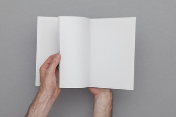 Book mockup. Male hand holding blank book.