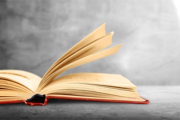 Open book on old wooden table