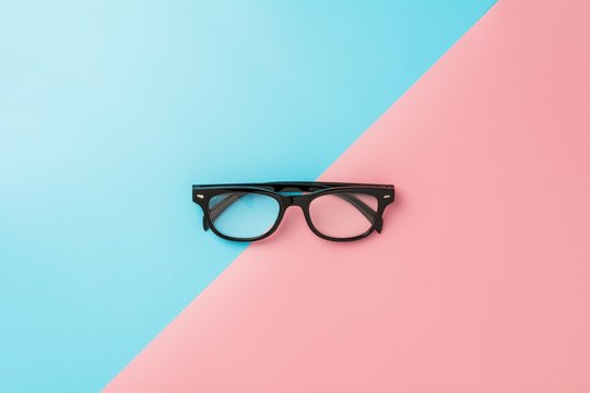 black glasses on blue and pink background.
