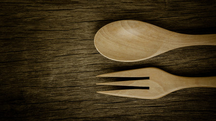 wood spoon and fork on old wooden desk. - vintage style.