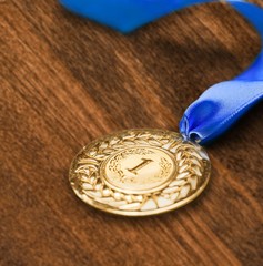 Gold medal with  ribbon on background