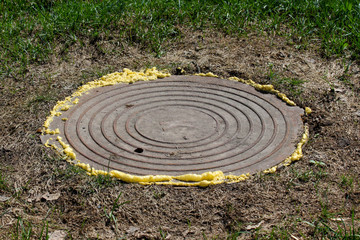 Manhole sealed with spray foam for safety reasons