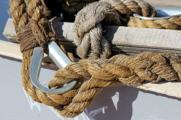 Closeup of two nautical ropes connected together: one with simple eye splice and one with eye splice with thimble