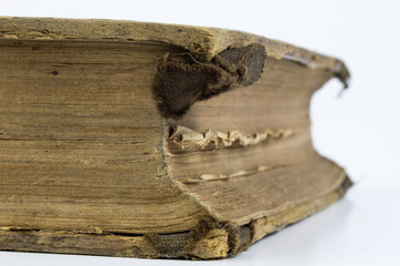 Old destroyed book on a white table. Cards and the back of an old publication.