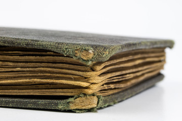 Old destroyed book on a white table. Cards and the back of an old publication.