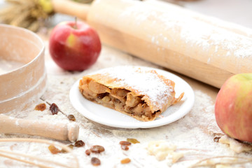 strudel (roll strudel) with apple on a wooden board with flour
