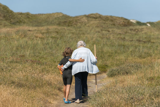 Grandchild Supports Grandma when Walking
