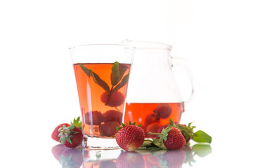 Sweet compote of ripe red strawberries in a glass decanter