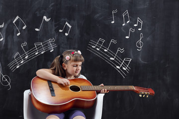 Schoolgirl playing the guitar