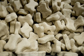 bowl full of dog biscuits, food, used as a prize or to clean the teeth, shaped like a bone