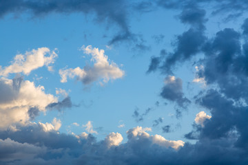 Blue sky with clouds close up image as a background during sunset time.