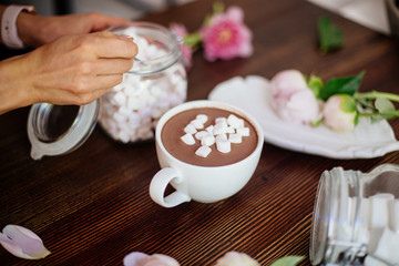 Cocoa with marshmallow and flowers.