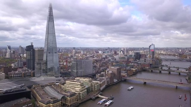 Panoramic Aerial Shot Along the River Thames in Central London, UK, Features The Shard Building, Bridges and the Millennium Wheel / London Eye in the background
