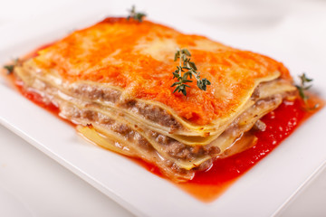 Italian Food. Hot tasty Classic Lasagna with bolognese sauce on white plate.