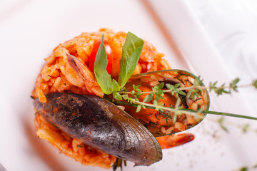 Italian Risotto with seafood, grilled prawns, mussels in a shell. Spanish paella. Mediterranean restaurant menu