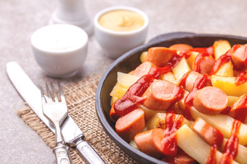 Peruvian Salchipapa Fries with sauces. French fries, sausages. Fastfood
