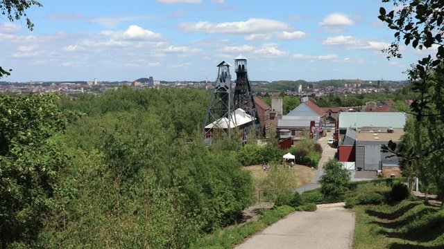 View of Bois du Cazier Coal Mine - Marcinelle, Belgium and the town of Charleroi behind