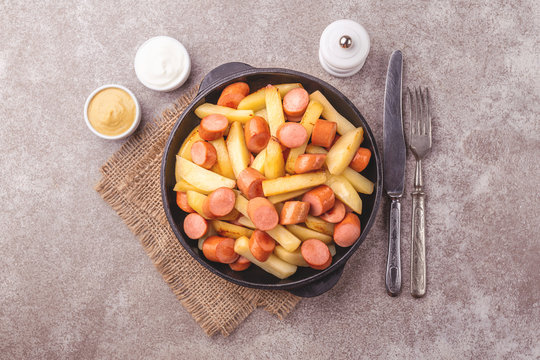 Peruvian Salchipapa Fries with sauces. French fries, sausages. Fastfood