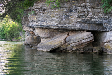 Fototapeta na wymiar Broken rock cliffs at the waters edge.
