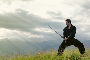 Man with sword, meditation on mountain