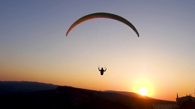 Close-up: paraglider is flying in the direction of the Sun
