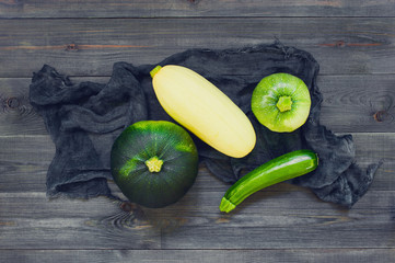 Dark composition with various zucchini and squashes