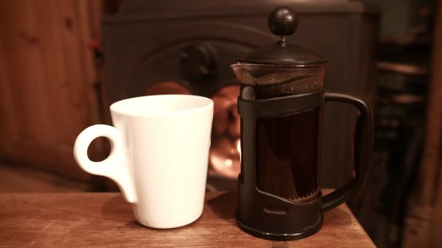 Coffee black brewing by fire on cold Winters day