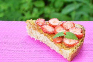 photo of delicious tasty strawberry sandwich. a sandwich with strawberries and peanut butterflies on a crimson background. top view, copy space. a healthy snack