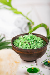 Obraz na płótnie Canvas Spa. Green herbal spirulina salt in ceramic bowl, spa towels, candles and bamboo