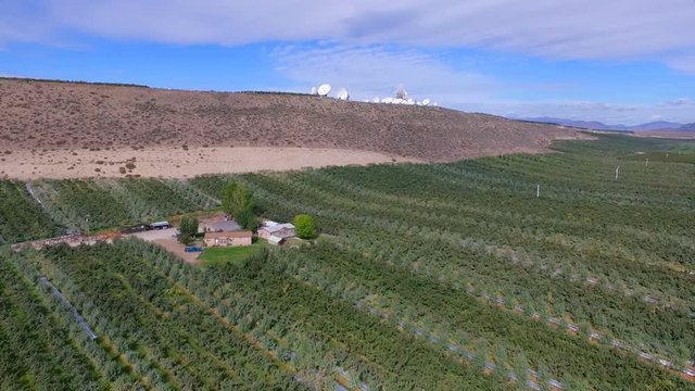 Rich Farmland in the Okanogan Valley below Satellite Dish Filled Hilltop