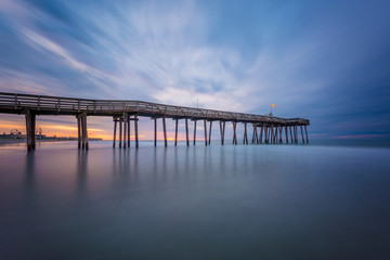Fototapeta premium A pier at sunrise in Ocean City, New Jersey.
