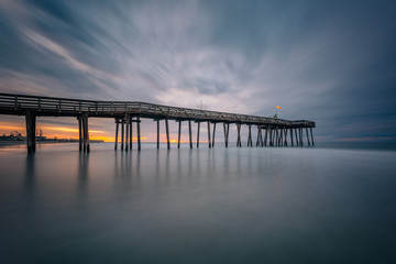 Fototapeta na wymiar A pier at sunrise in Ocean City, New Jersey.
