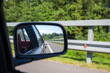 view of the road in the reflection of a side view mirror