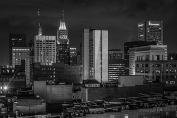 Fototapeta na wymiar View of the skyline at night, in Baltimore, Maryland