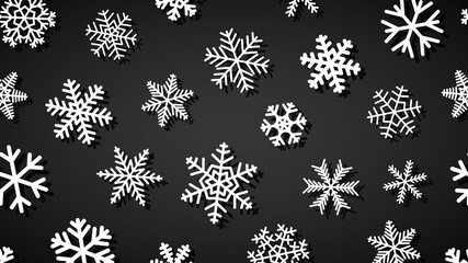 Christmas background of snowflakes of different shapes and sizes with shadows. White on black.
