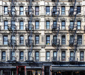 Wall of windows on an old apartment building in the Lower East Side neighborhood of Manhattan, New York City © deberarr