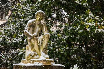 Thinking man statue at the Luxembourg Palace garden in a freezing winter day day just before spring