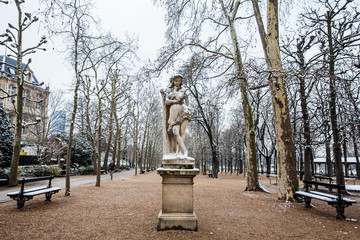 Veleda statue and a man running at the Luxembourg Palace garden in a freezing winter day just...