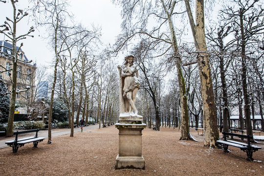 Veleda statue and a man running at the Luxembourg Palace garden in a freezing winter day just before spring