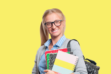 Happy young student girl holding books.  Back to school
