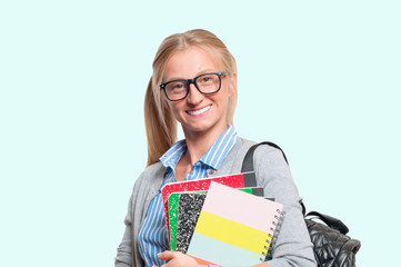 Happy young student girl holding books.  Back to school