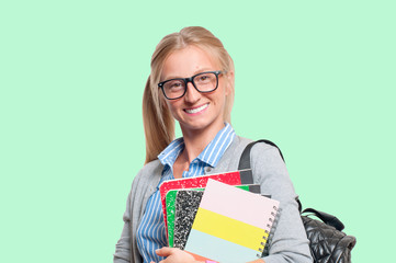 Happy young student girl holding books.  Back to school