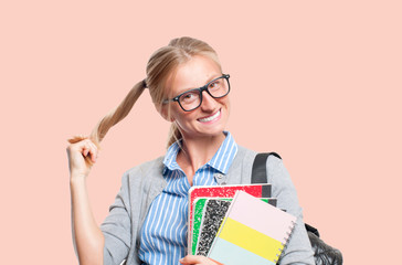 Happy young student girl holding books.  Back to school