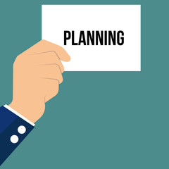 Man showing paper PLANNING text