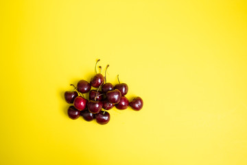 Cherries on yellow background