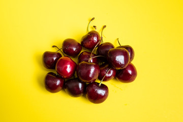 Cherries on yellow background