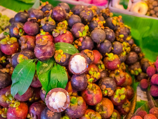 Mangosteen fruits sell on the market in Thailand.The flesh of the queen of friuts, Delicious mangosteen fruit arranged on a bowl.