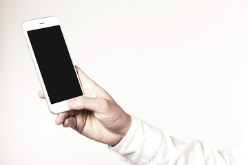 Fototapeta na wymiar business man hand hold a mobile phone on the white background.