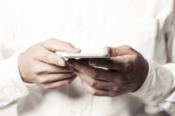 business man hand hold a mobile phone on the white background.