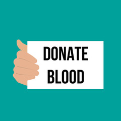 Man showing paper DONATE BLOOD text